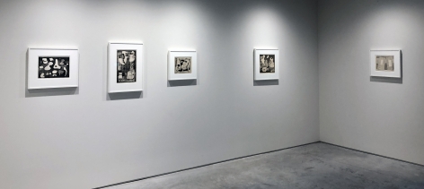 Five black and white prints by Alice Trumbull Mason hanging on a white wall