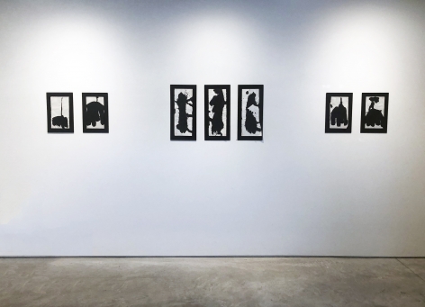 Installation view of seven black ink drawings on white paper mounted on black matts by Richard Stankiewicz