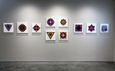 Ten works on paper by Jack Youngerman under plexi box frames installed on white walls